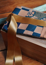 Load image into Gallery viewer, Ravissante ceinture de style obi, cet accessoire tendance, pièce incontournable de la garde-robe met la taille en valeur et affine la silhouette. Les côtés sont en soie de couleur cuivre et le motif central est un obi en motif de damiers vert et doré cuivré avec du violet profond. Le ruban en satin est or vieilli.

